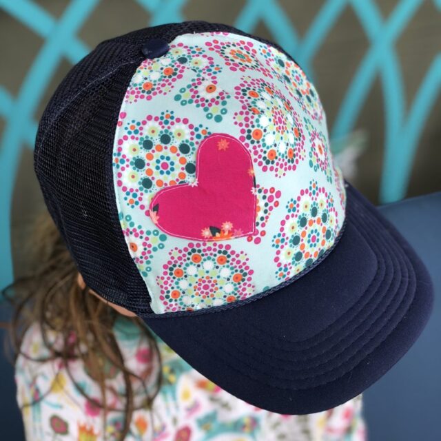 cap with patterned design and heart patch