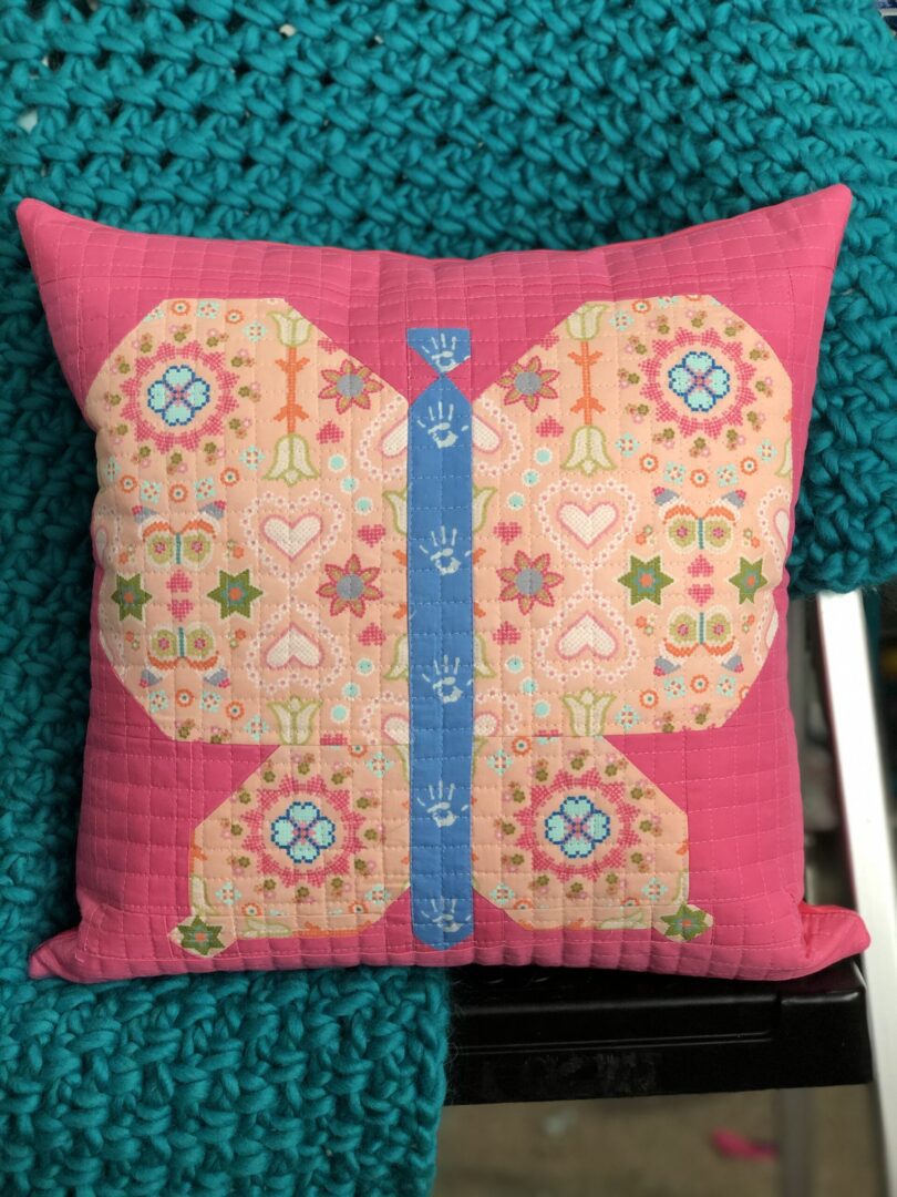 A pink butterfly pillow