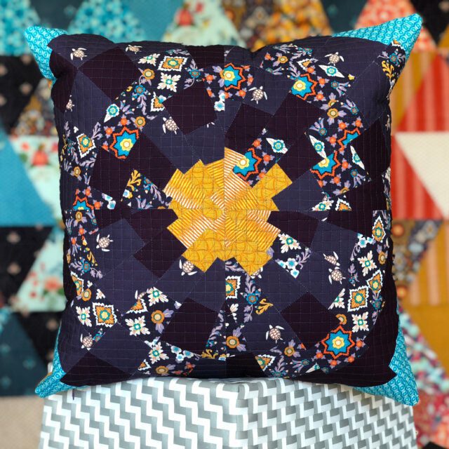 black pillow with colorful pattern and blue tips