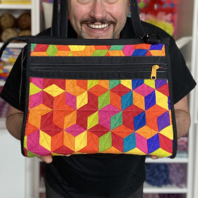 Mathew holding a bag he crafted
